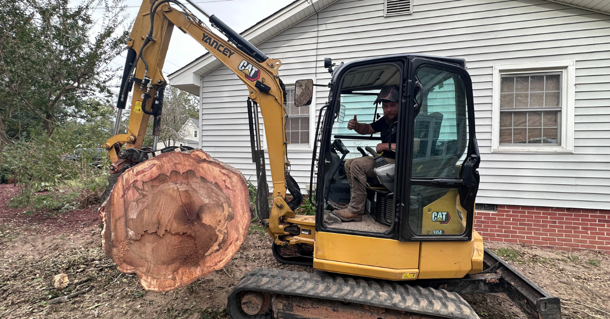 FLS Tree Service crew grinding a large tree stump in a residential backyard in Georgia
